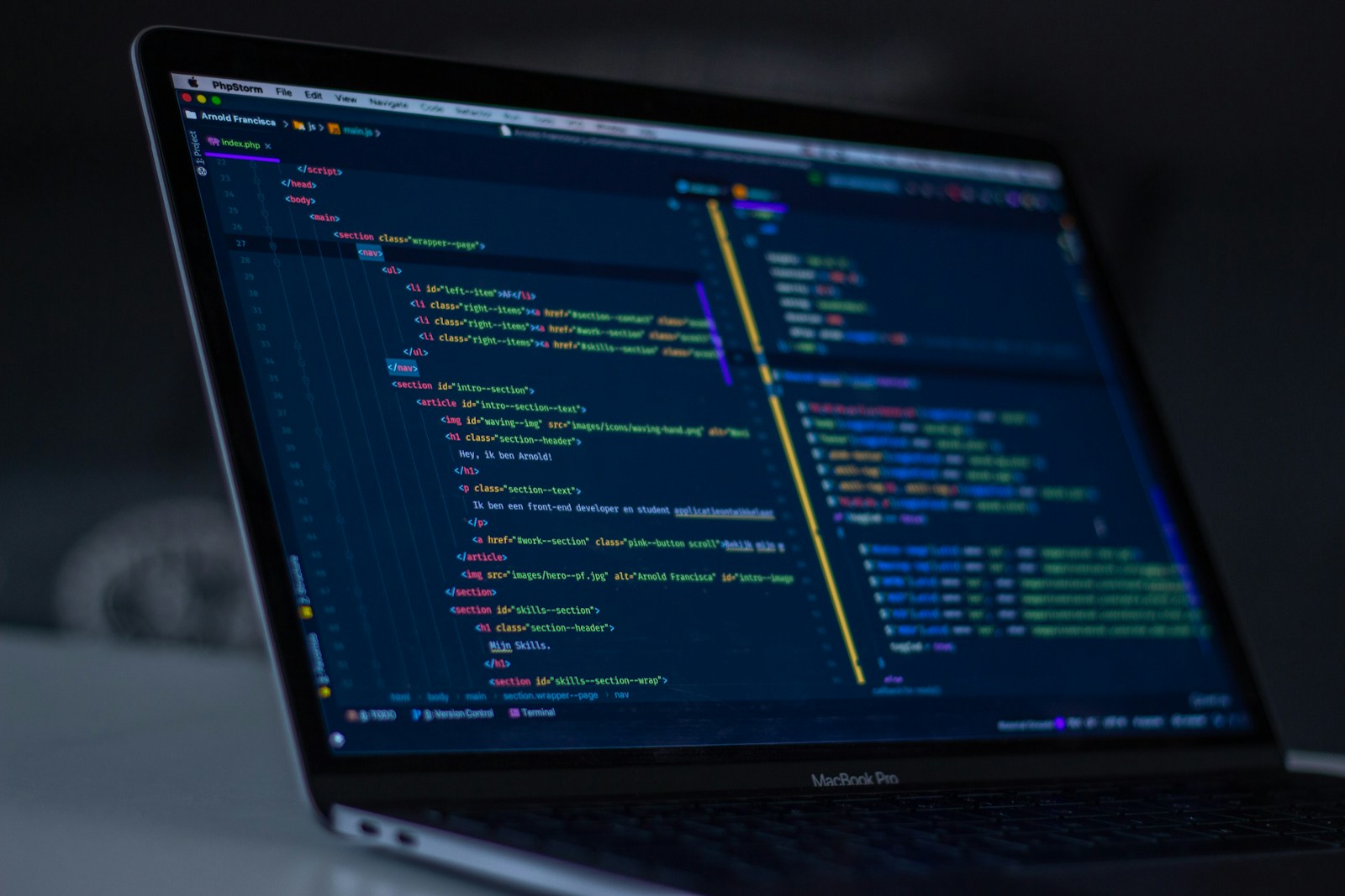 Colorful code on a monitor in a dark room