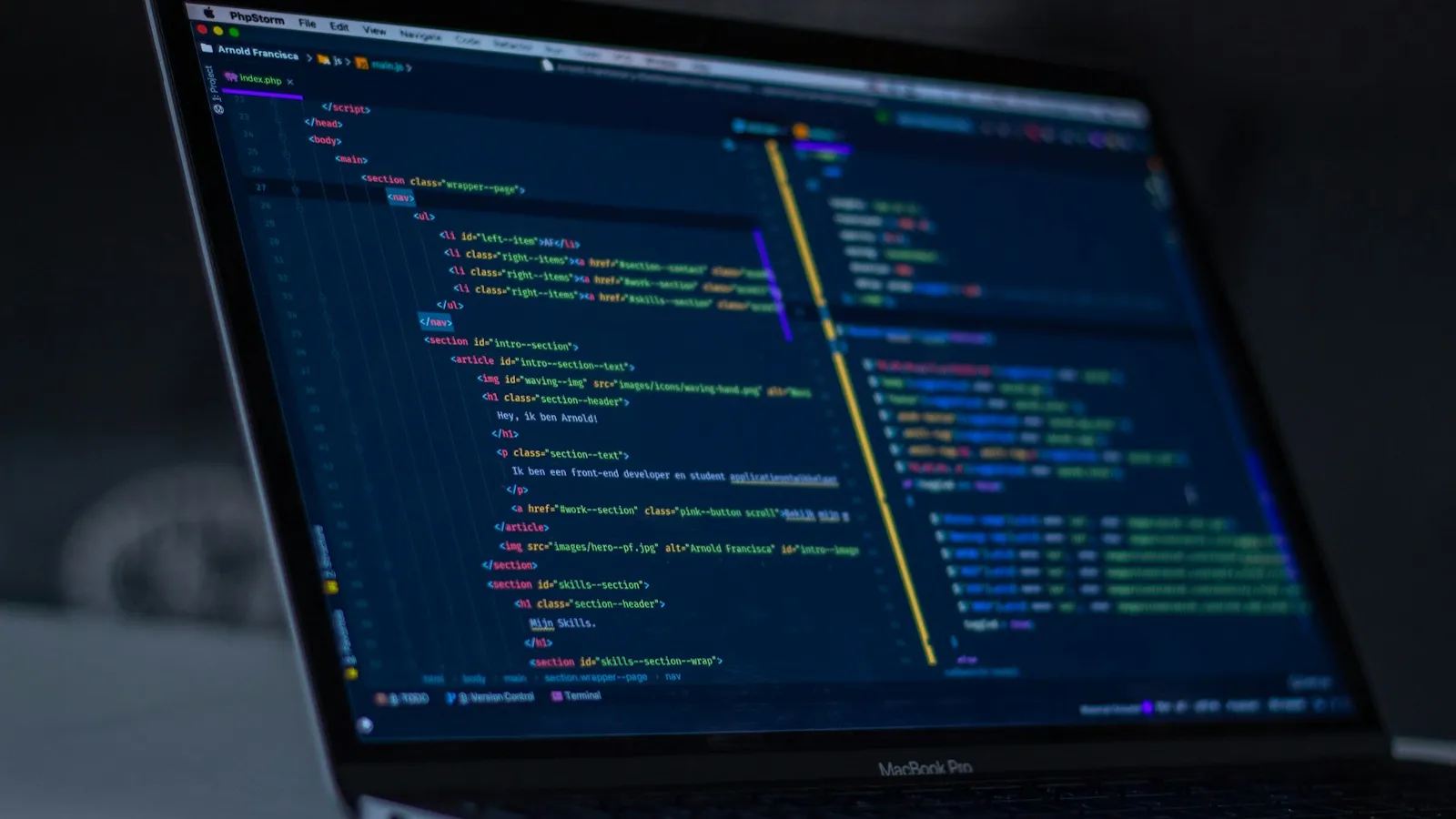 Colorful code on a monitor in a dark room